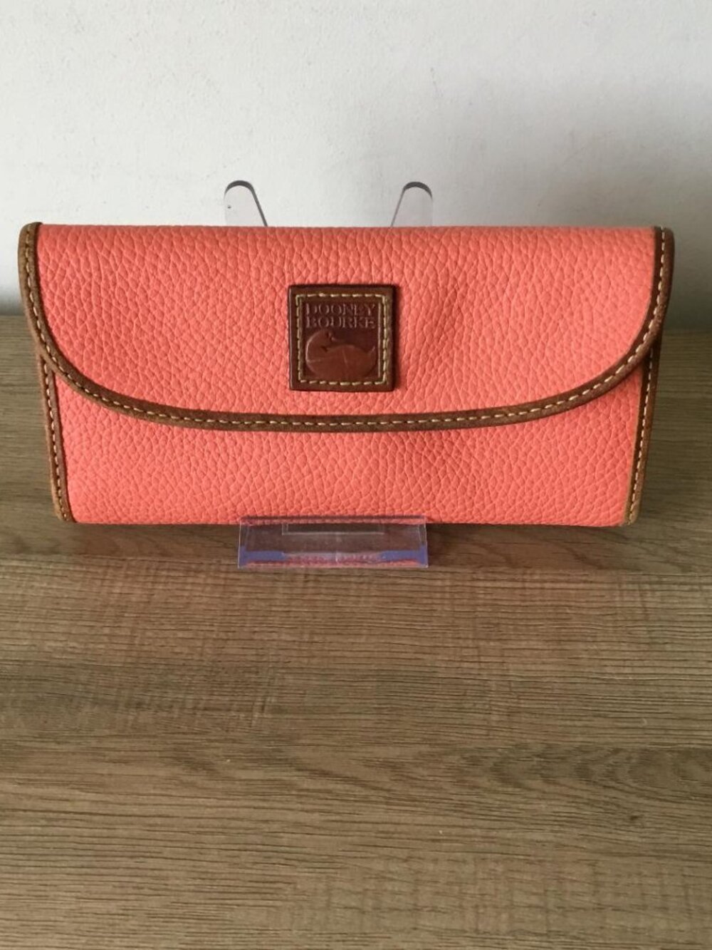 Dooney & Bourke Pebble Grain Continental Clutch Wallet in Coral Colored Leather